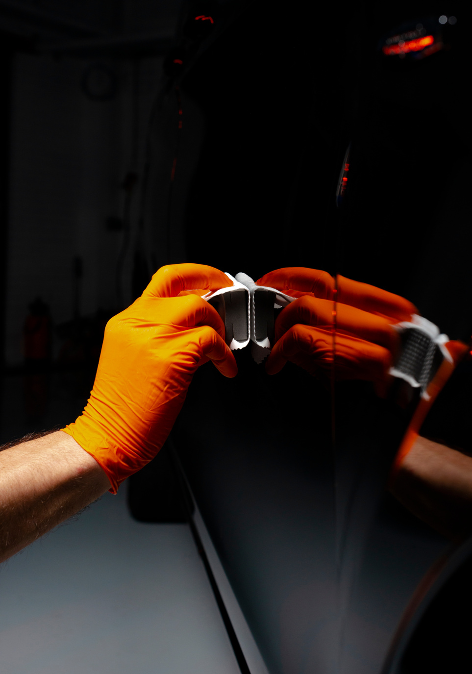 Car polish wax worker hands polishing car